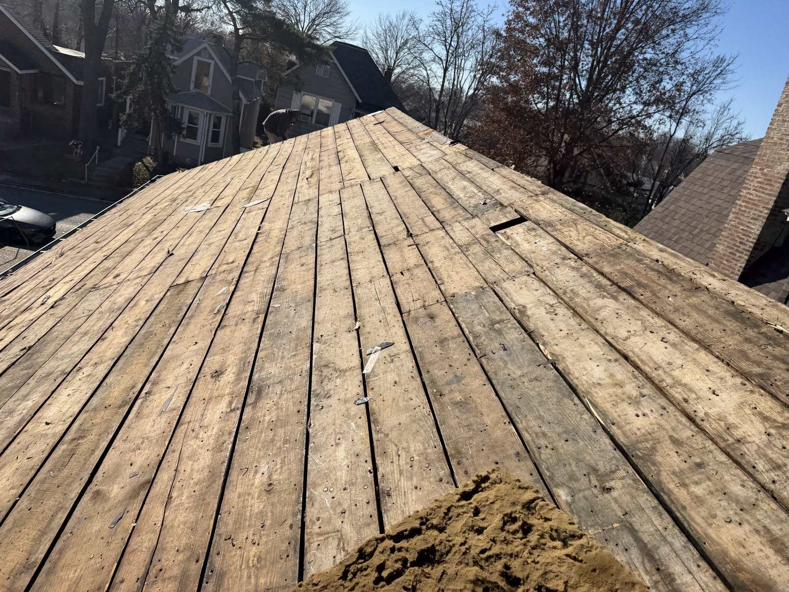 Plank roof decking exposed after the old shingles came off, on an ordinary St. Louis street